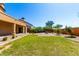 A large green lawn and desert landscaping fill the spacious backyard of this home at 31604 N 19Th Ave, Phoenix, AZ 85085