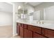 Bathroom with a double sink vanity, a large mirror and bright lighting at 31604 N 19Th Ave, Phoenix, AZ 85085