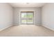 Spacious bedroom with plush carpet and sliding glass doors to a private backyard at 31604 N 19Th Ave, Phoenix, AZ 85085