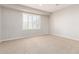 Bright bedroom with neutral walls, plush carpet flooring, and a shuttered window at 31604 N 19Th Ave, Phoenix, AZ 85085