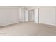 An airy bedroom features neutral walls and carpet, complemented by white doors and trim at 31604 N 19Th Ave, Phoenix, AZ 85085