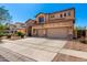 Two-story home featuring a three-car garage, stone accents, and a beautiful desert landscaped front yard at 31604 N 19Th Ave, Phoenix, AZ 85085