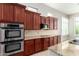Updated kitchen features stainless steel double oven, granite countertops, and wooden cabinetry at 31604 N 19Th Ave, Phoenix, AZ 85085
