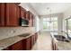 Stylish kitchen with tile backsplash, granite countertops, and stainless steel appliances at 31604 N 19Th Ave, Phoenix, AZ 85085