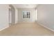 Spacious living room featuring neutral walls, plush carpeting, and large windows for natural light at 31604 N 19Th Ave, Phoenix, AZ 85085