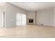 Open living room with fireplace, tile flooring and sliding glass door to the exterior at 31604 N 19Th Ave, Phoenix, AZ 85085