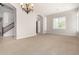 Bright living room with archways, staircase, neutral paint, and plantation shutters at 31604 N 19Th Ave, Phoenix, AZ 85085