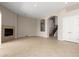 Open floor plan with fireplace, tile floors, and archways to the staircase at 31604 N 19Th Ave, Phoenix, AZ 85085