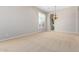 Spacious living room featuring neutral walls, plush carpeting, and large windows for natural light at 31604 N 19Th Ave, Phoenix, AZ 85085