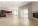 Spacious living and kitchen area with tile floors, fireplace, and an open floor plan at 31604 N 19Th Ave, Phoenix, AZ 85085