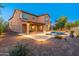 Backyard featuring a pool, covered patio, desert landscaping, and outdoor lighting at 3603 E Salter Dr, Phoenix, AZ 85050