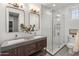 Bathroom featuring a glass shower, dual sinks, and tile flooring at 3603 E Salter Dr, Phoenix, AZ 85050