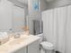 Well-lit bathroom with a shower-tub combination, white vanity, toilet, and soft gray walls, creating a clean and functional space at 3603 E Salter Dr, Phoenix, AZ 85050