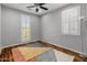 Bedroom has hardwood flooring and two windows with plantation shutters at 3603 E Salter Dr, Phoenix, AZ 85050