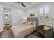 Comfortable bedroom with neutral tones, a ceiling fan, and a window with shutters at 3603 E Salter Dr, Phoenix, AZ 85050