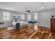 Spacious bedroom featuring hardwood floors, plantation shutters, and a second bed in the connected flex room at 3603 E Salter Dr, Phoenix, AZ 85050