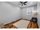 Light filled room has hardwood floors, ceiling fan, and plantation shutters at 3603 E Salter Dr, Phoenix, AZ 85050