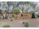 Stone signage for Fireside Clubhouse with surrounding desert landscaping, native trees and bushes at 3603 E Salter Dr, Phoenix, AZ 85050