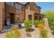 Exterior view of a brown two-story home with beautiful landscaping, a patio, and lovely curb appeal at 3603 E Salter Dr, Phoenix, AZ 85050