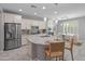 Modern kitchen featuring stainless steel appliances, a large island with seating, and stylish pendant lighting at 3603 E Salter Dr, Phoenix, AZ 85050