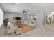 Open-concept living room with tile floors, ceiling fan, comfortable seating, and seamless access to other rooms at 3603 E Salter Dr, Phoenix, AZ 85050