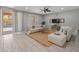 Spacious living room features tile flooring, a ceiling fan, and sliding glass doors leading to the backyard at 3603 E Salter Dr, Phoenix, AZ 85050