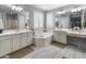 A spacious primary bathroom with double sinks, soaking tub and bright natural light at 3603 E Salter Dr, Phoenix, AZ 85050
