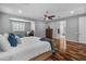 Main bedroom with ceiling fan, wood floors and ensuite bathroom at 3603 E Salter Dr, Phoenix, AZ 85050