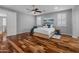 Bedroom with hardwood floors, ceiling fan, shutters and abundant natural light at 3603 E Salter Dr, Phoenix, AZ 85050