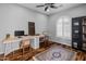 Home office with natural light, wood floors, a long desk, and built-in bookcase at 3603 E Salter Dr, Phoenix, AZ 85050