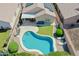 Backyard features a pool, artificial grass, paver patio, and covered seating area at 3612 W Charlotte Dr, Glendale, AZ 85310