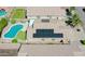 Aerial view of a home with solar panels, a pool in the backyard, and a paver patio at 3612 W Charlotte Dr, Glendale, AZ 85310