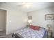 Comfortable bedroom with a ceiling fan, wood-look flooring, and soothing, neutral-colored walls at 3612 W Charlotte Dr, Glendale, AZ 85310