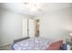 Bedroom features a ceiling fan, closet, neutral paint, and wood-look flooring at 3612 W Charlotte Dr, Glendale, AZ 85310