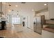 Well-lit kitchen featuring stainless steel appliances, white cabinets, and a cozy breakfast nook area at 3612 W Charlotte Dr, Glendale, AZ 85310