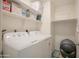 Efficient laundry room with a washer, dryer, and ample shelving for storage and organization at 3612 W Charlotte Dr, Glendale, AZ 85310