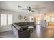 Open-concept living room featuring hardwood floors, a cozy sofa, and seamless flow to the kitchen at 3612 W Charlotte Dr, Glendale, AZ 85310