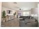 Inviting living room with hardwood floors, a comfortable gray sofa, and plenty of natural light at 3612 W Charlotte Dr, Glendale, AZ 85310