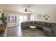Spacious living room with modern decor, a ceiling fan, and a sliding glass door at 3612 W Charlotte Dr, Glendale, AZ 85310