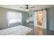 Inviting bedroom featuring a work desk, a bright window with sheer curtains, and stylish barn door access to the en-suite at 3612 W Charlotte Dr, Glendale, AZ 85310