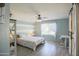 Charming bedroom with a unique accent wall, a ceiling fan, and an en-suite bathroom accessed through a barn door at 3612 W Charlotte Dr, Glendale, AZ 85310