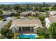 Expansive aerial shot of a beautiful home showcasing a large pool and surrounding lush landscaping at 3671 S Greythorne Way, Chandler, AZ 85248