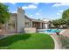Well manicured lawn and desert landscaping complement the backyard pool and covered patio at 3671 S Greythorne Way, Chandler, AZ 85248