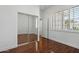 Bright bedroom features wood floors, mirrored closet doors, and white window shutters at 3671 S Greythorne Way, Chandler, AZ 85248