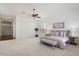 Expansive bedroom featuring a ceiling fan, shuttered windows, and a comfortable bed at 3671 S Greythorne Way, Chandler, AZ 85248