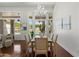 Dining room features hardwood floors, chandelier, large windows, and view to the backyard pool at 3671 S Greythorne Way, Chandler, AZ 85248