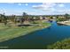 Scenic aerial view of a golf course with a tranquil lake and well-maintained greens at 3671 S Greythorne Way, Chandler, AZ 85248