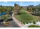 Scenic view of a golf course and community entrance with lush landscaping and a lake at 3671 S Greythorne Way, Chandler, AZ 85248