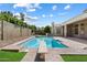 A diving board adds fun to this private pool surrounded by a block fence and green grass at 3671 S Greythorne Way, Chandler, AZ 85248