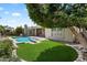 A luxurious backyard pool features a well-manicured lawn and mature landscaping at 3671 S Greythorne Way, Chandler, AZ 85248